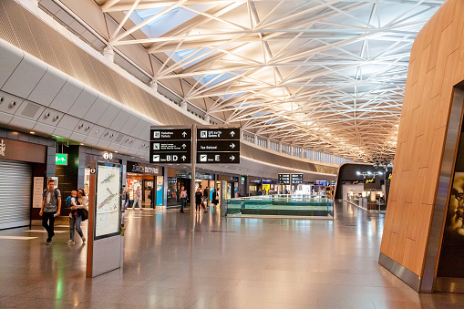 Shot of empty airport with duty-free shops and skylight.