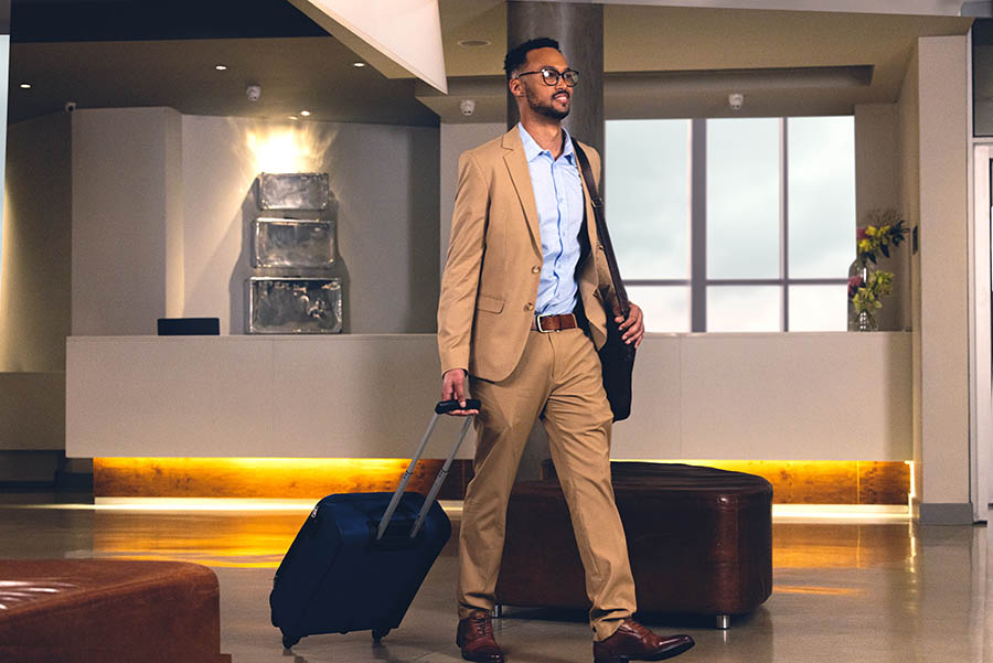 A man in a suit with a suitcase.