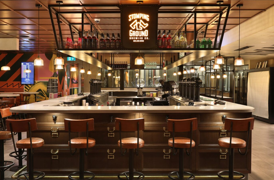 Cozy bar with counter and stools in Stomping Ground Brewery and Beer Hall, inviting patrons to relax and enjoy drinks, Melbourne Airport, Melbourne