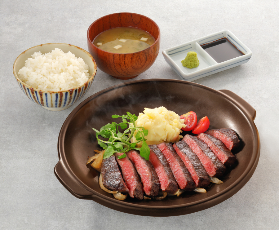 A delicious plate of steak, rice, and soup, perfectly cooked and beautifully presented.